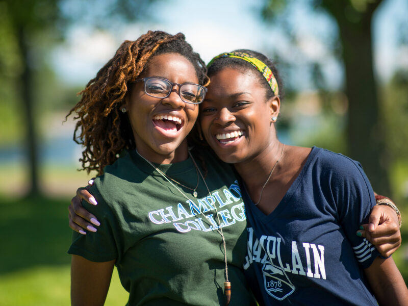 smiling students exchange hug