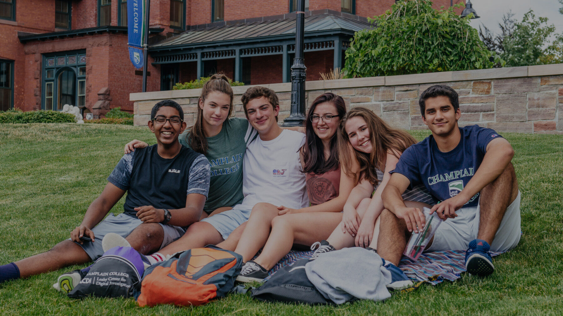 a group of friends sitting on the grass